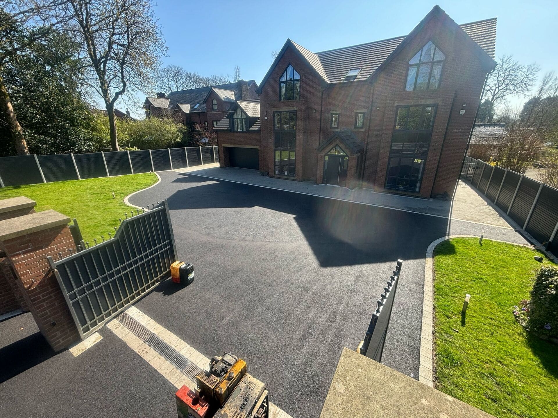 Freshly laid tarmac driveway at a large gated house